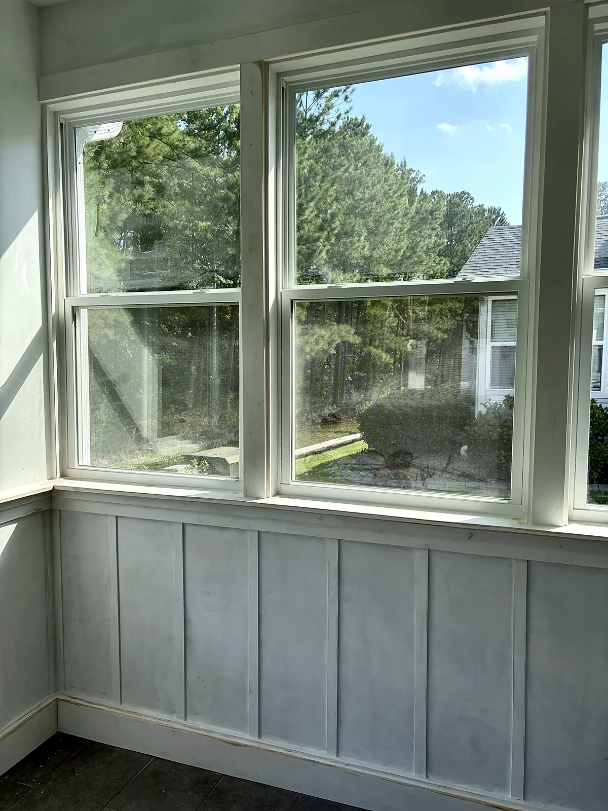 Sunroom with board-and-batten wainscot and window wall