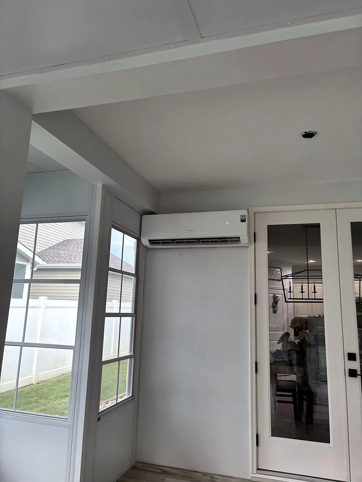 Sunroom with mini-split and French doors to the house