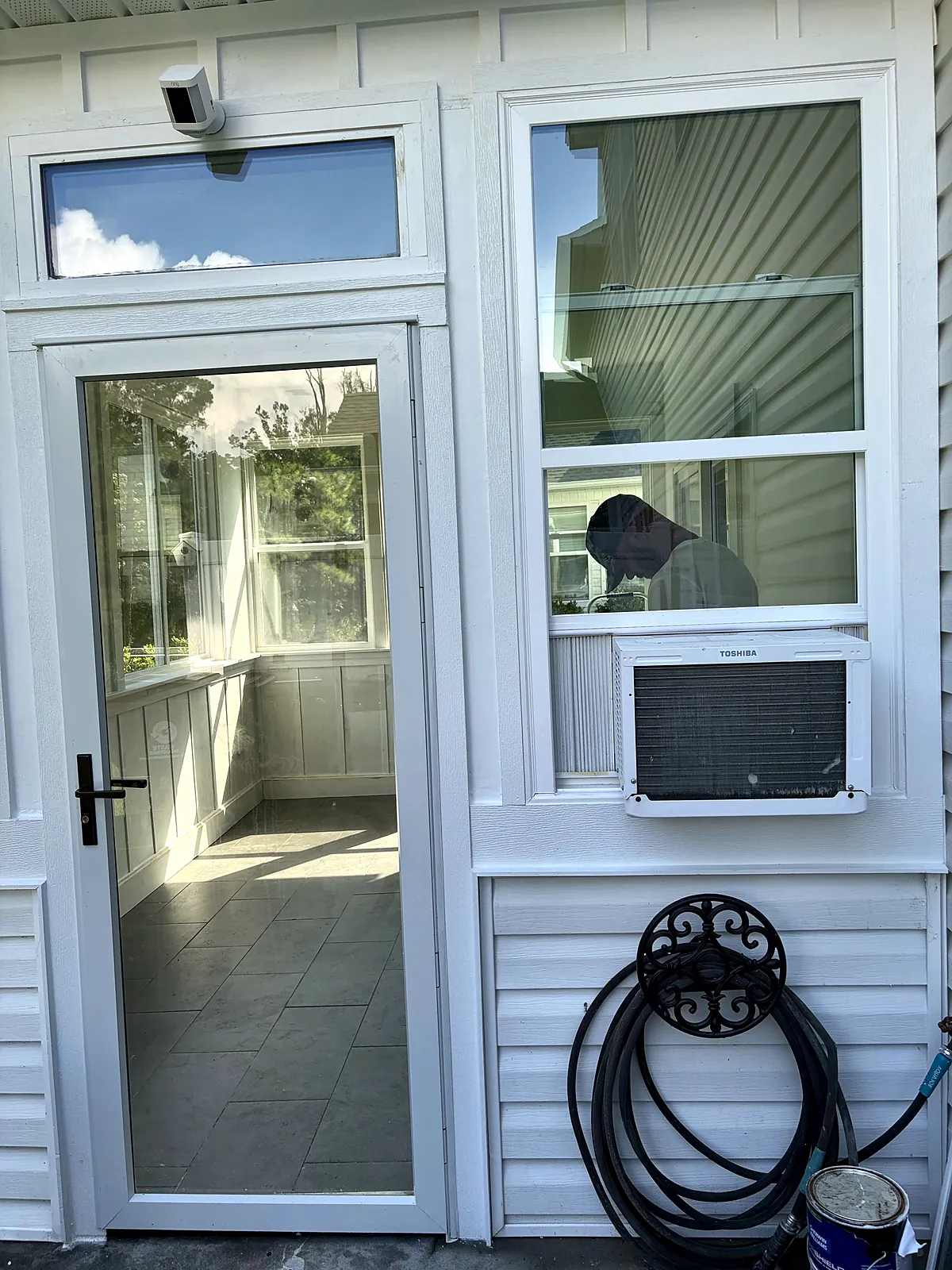 Glass storm door entry to the sunroom