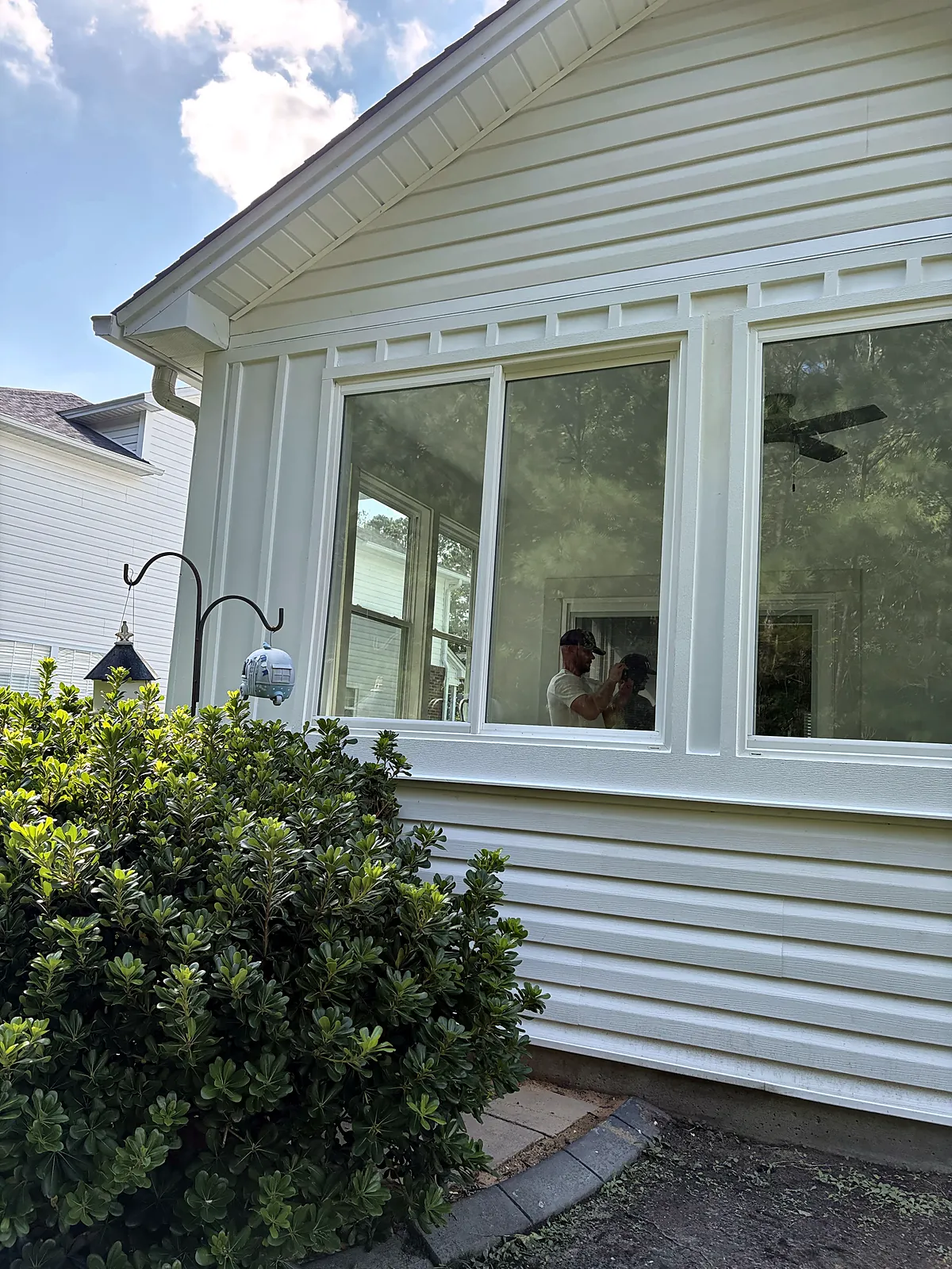 Sunroom addition exterior with landscaping