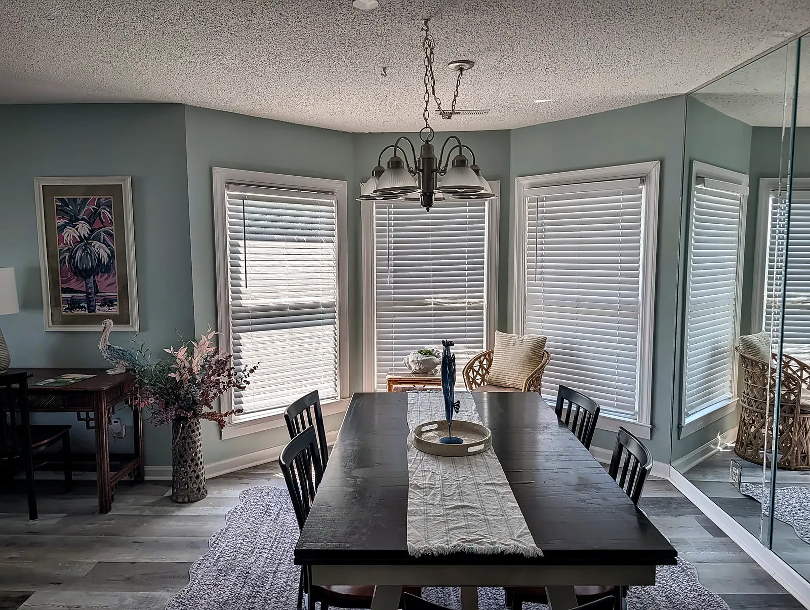 Condo dining area with bay windows and chandelier