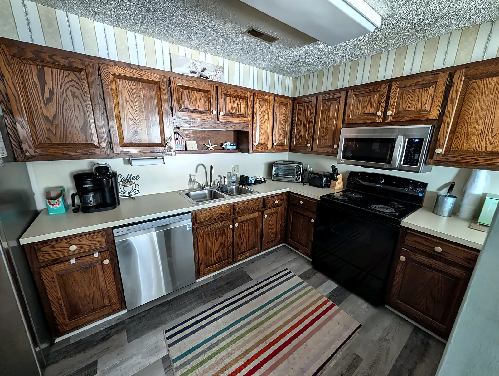 Condo kitchen with wood cabinets and stainless appliances