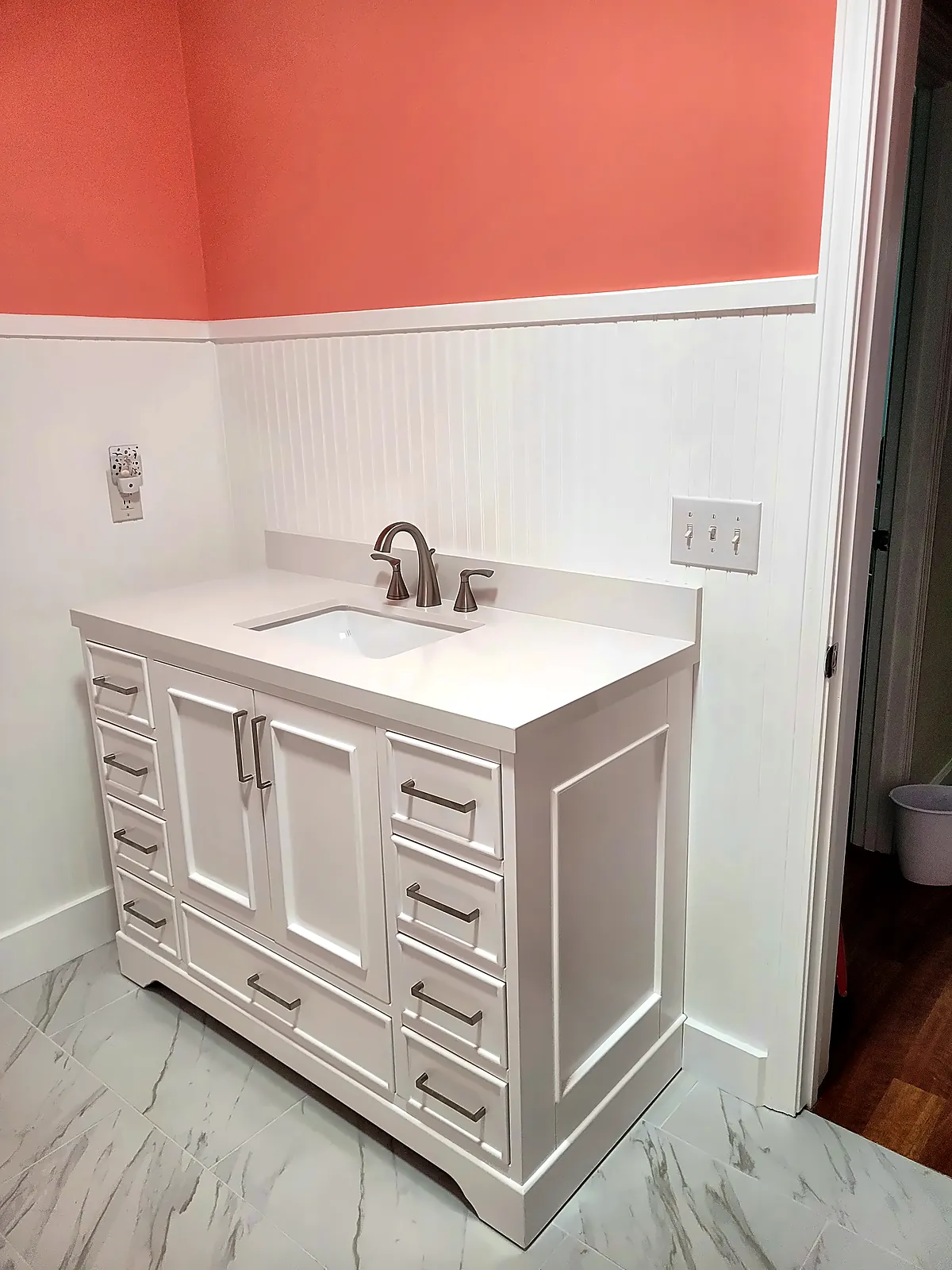 White shaker vanity with quartz top and chrome faucet