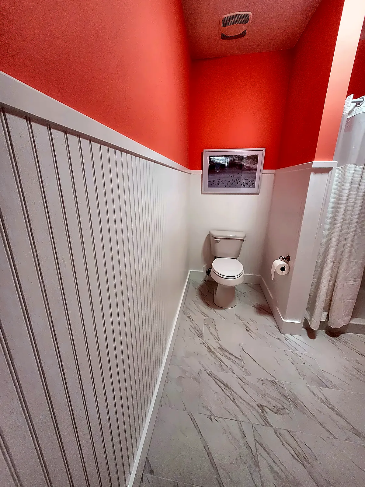 Bathroom with beadboard wainscot and toilet alcove