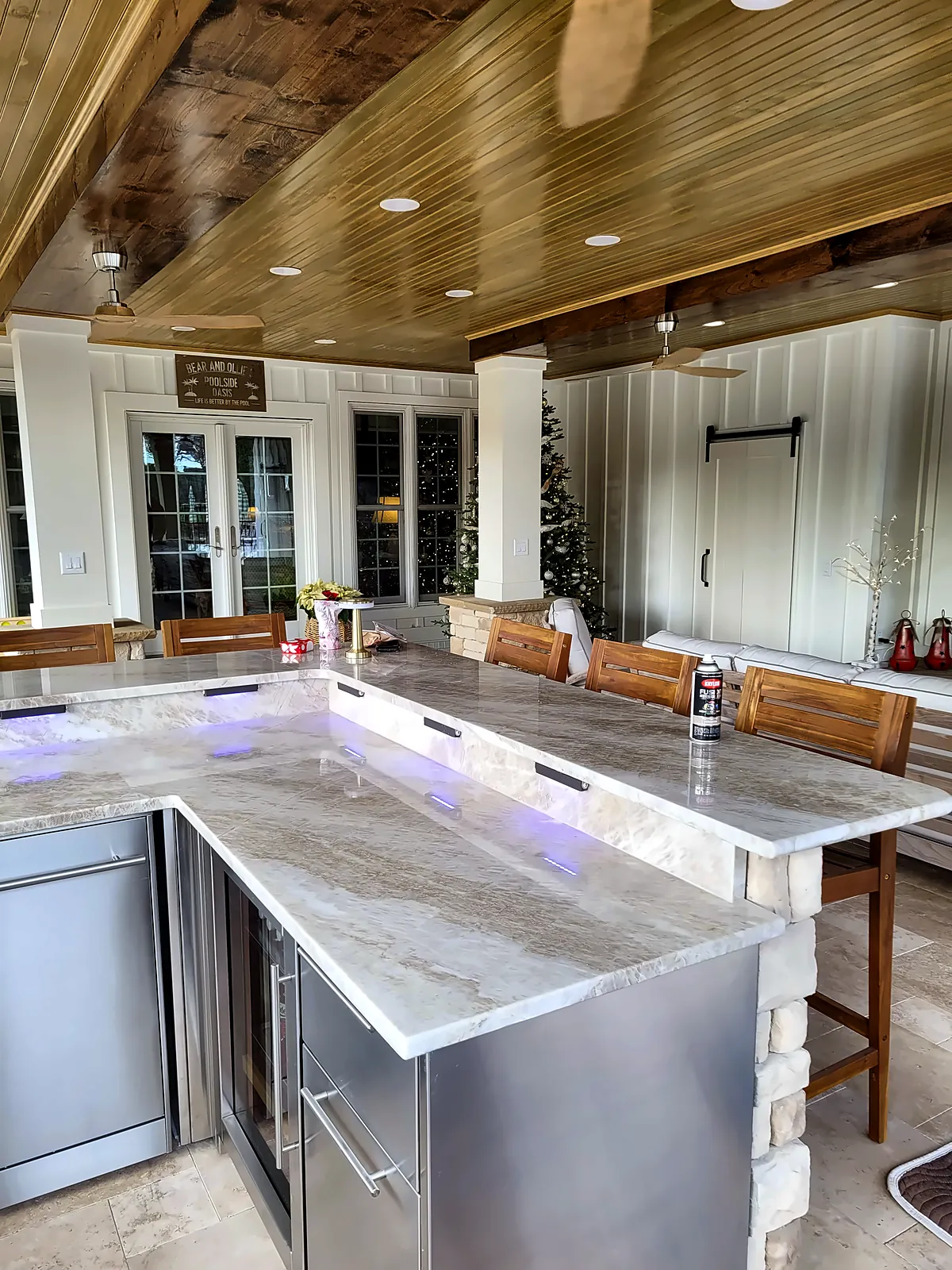 Outdoor bar seating under tongue-and-groove wood ceiling