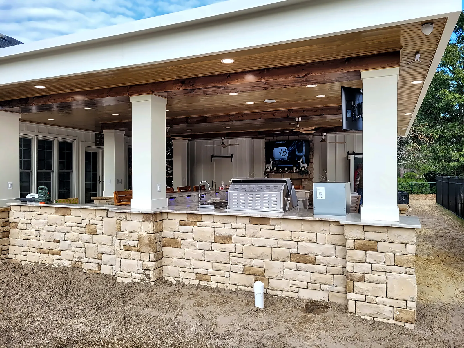 Finished pavilion exterior with stacked-stone knee wall and columns