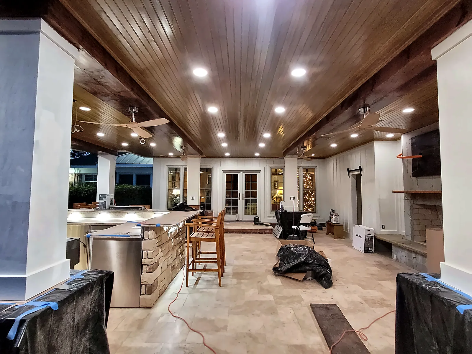 Pavilion interior with travertine floor and outdoor kitchen