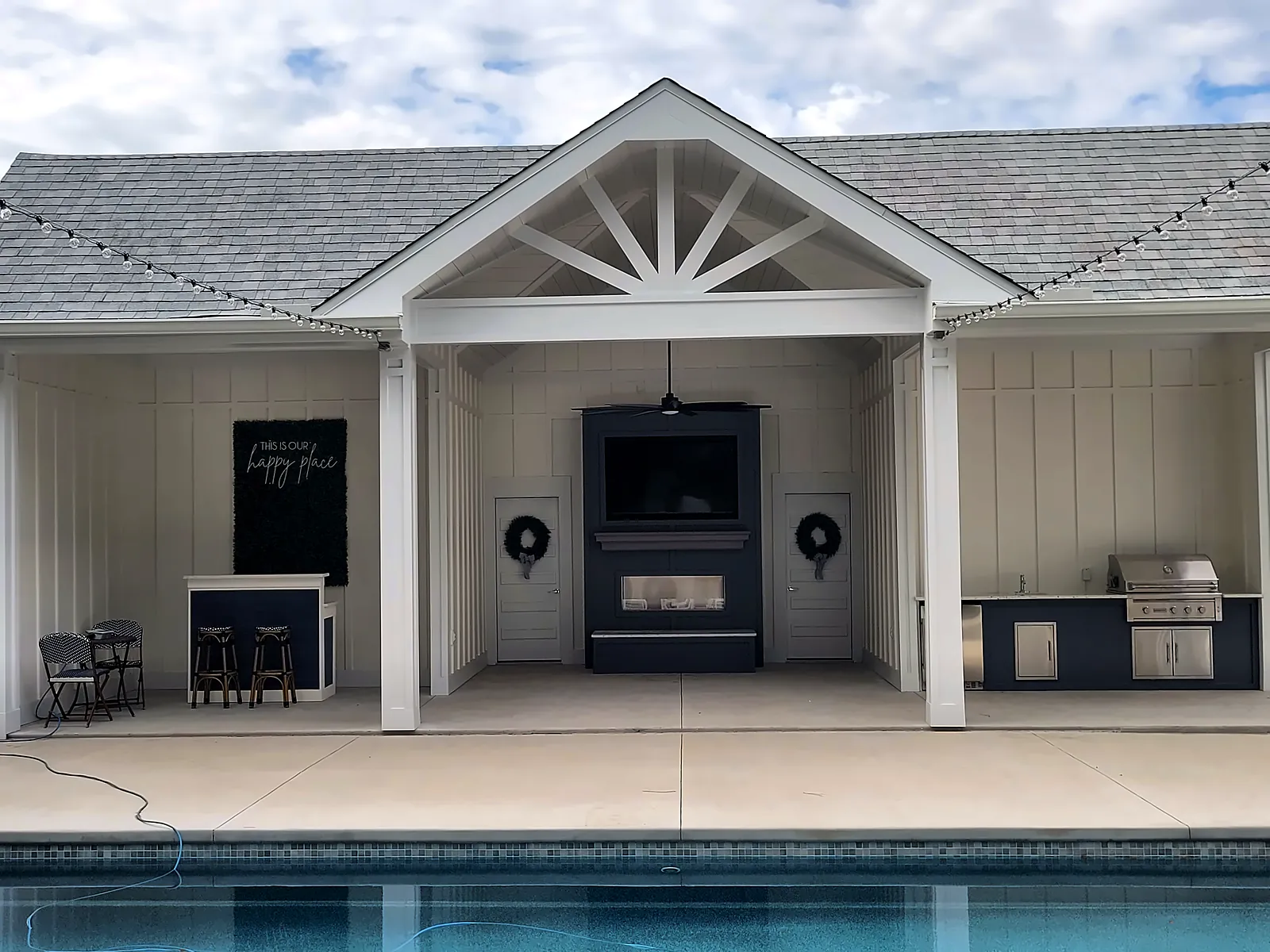 Finished pool house exterior with covered cabana, outdoor kitchen and pool