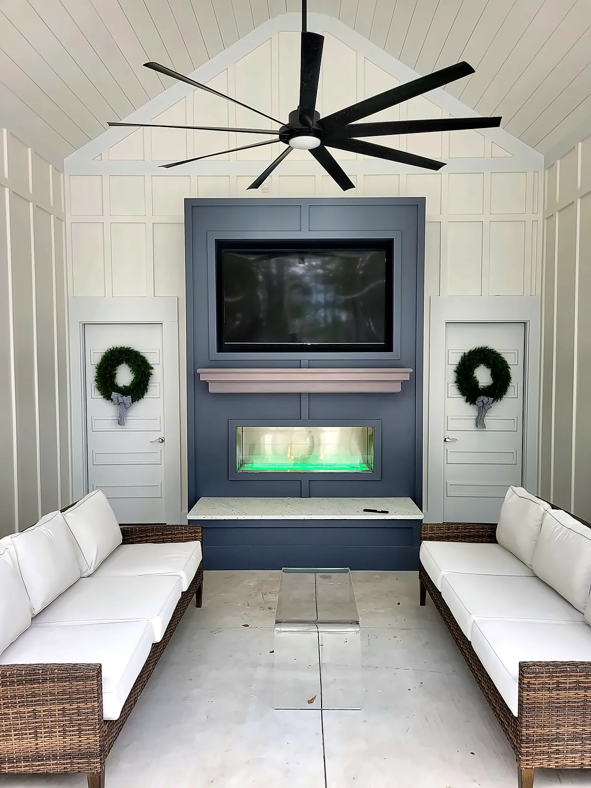 Cabana lounge with linear fireplace, TV wall and white outdoor sofas