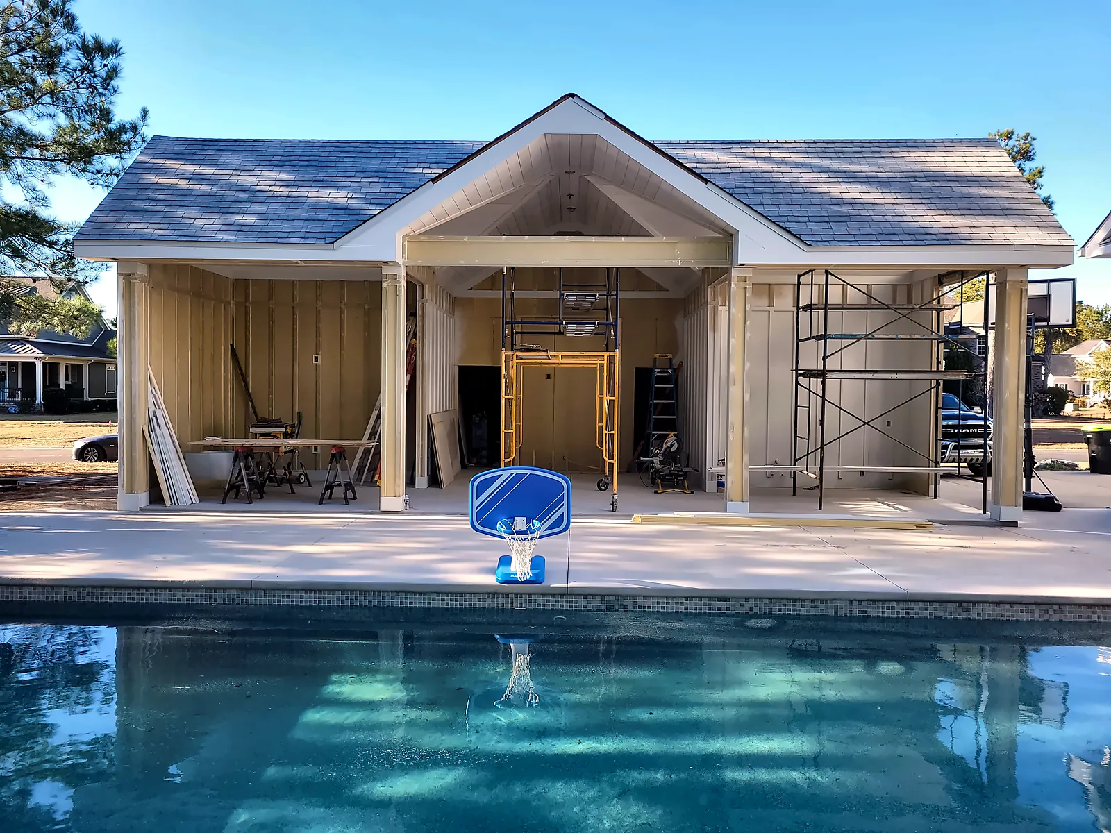 Pool house under construction beside the pool