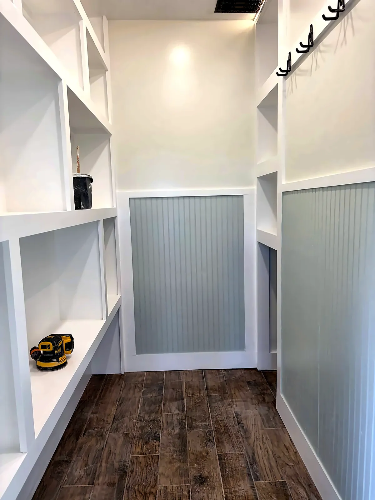 Custom closet with painted built-in shelving and LED lighting