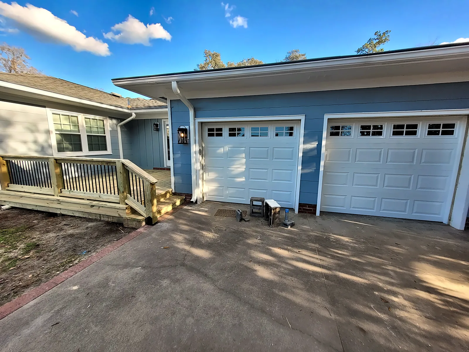Exterior with new front deck and double garage doors