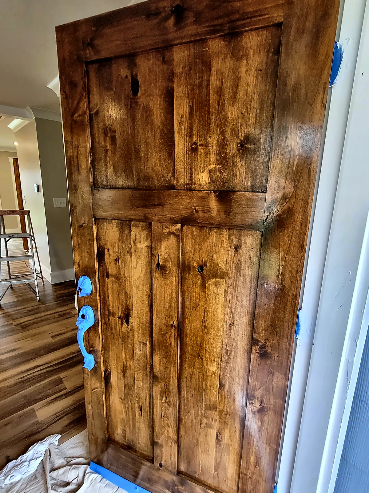 Stained knotty-wood door installed during renovation
