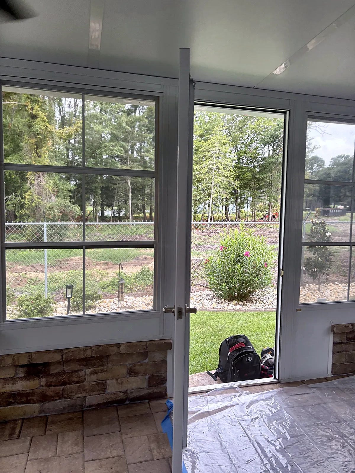 Sunroom with glass door and stone knee wall