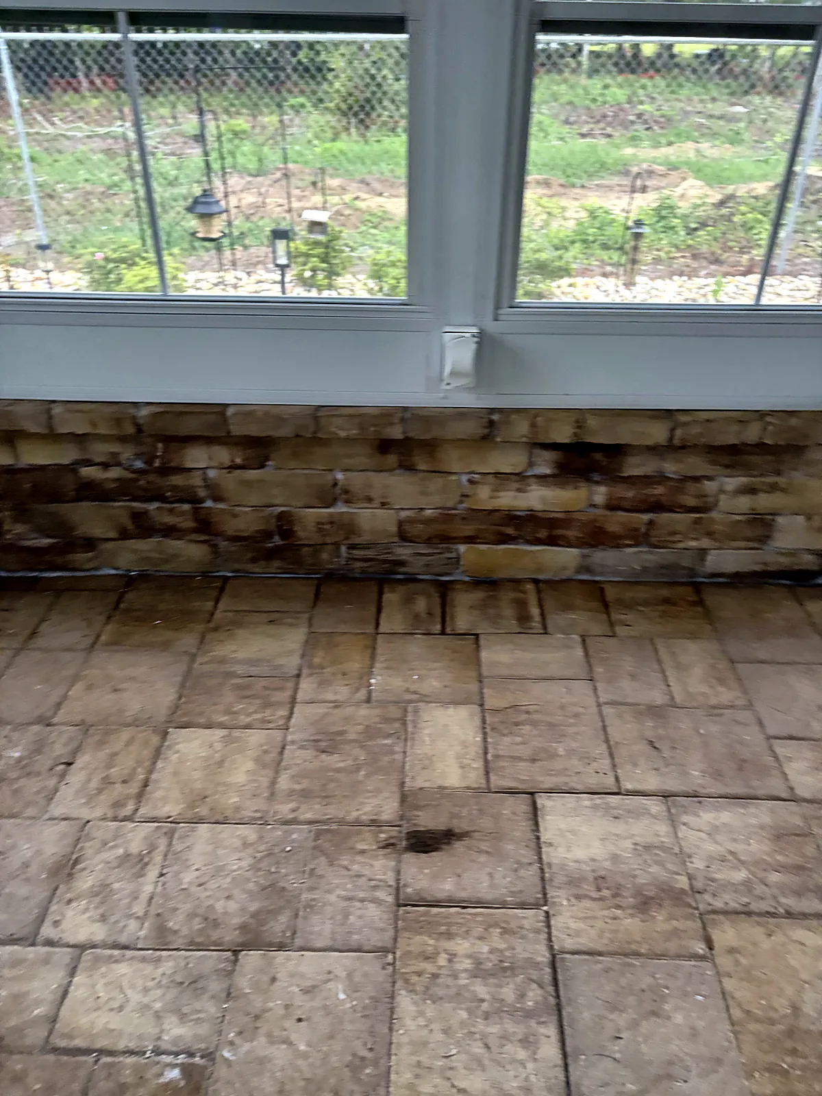 Stone knee wall and paver floor under window wall