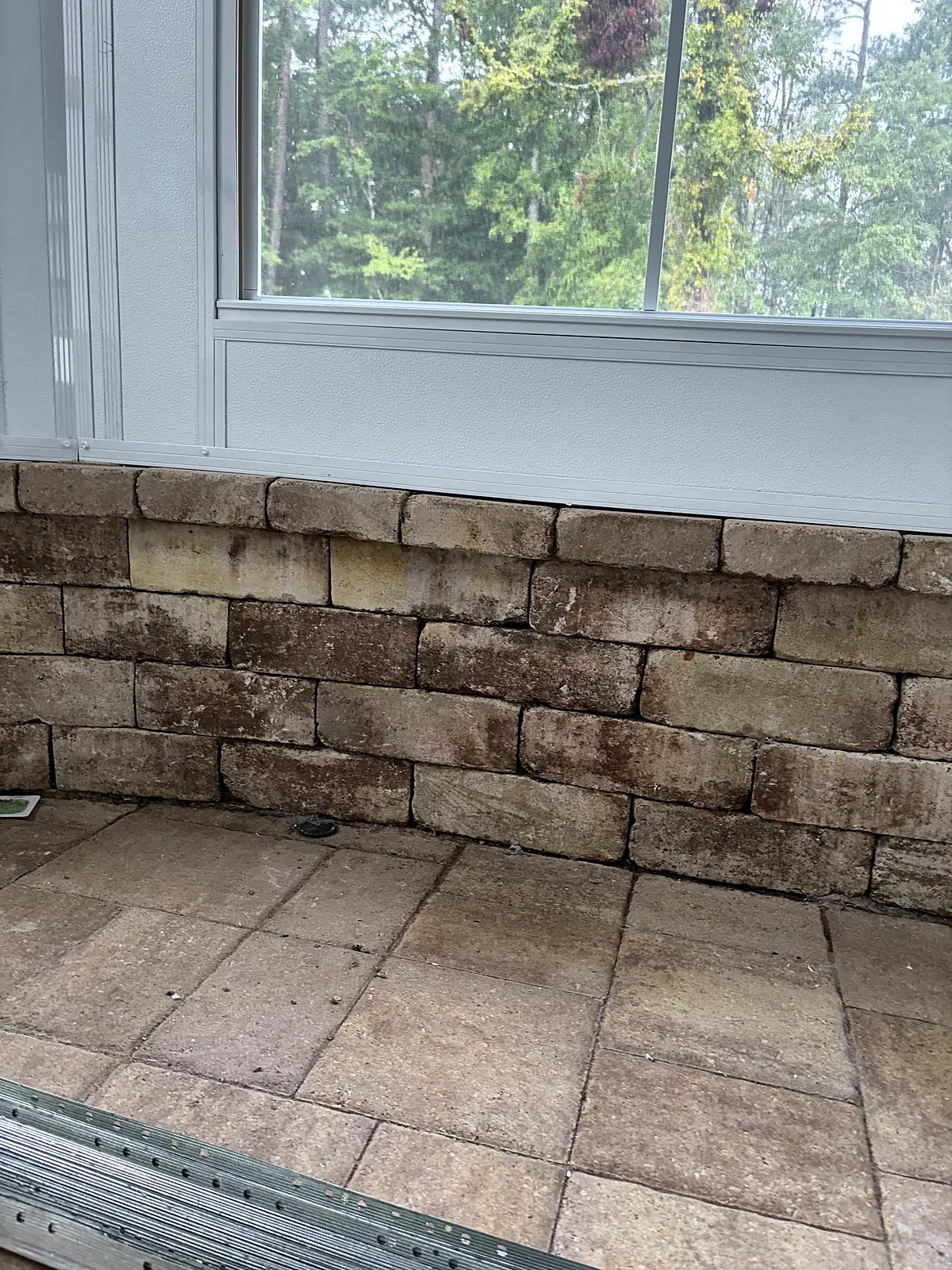 Detail of stacked-stone knee wall below sunroom windows