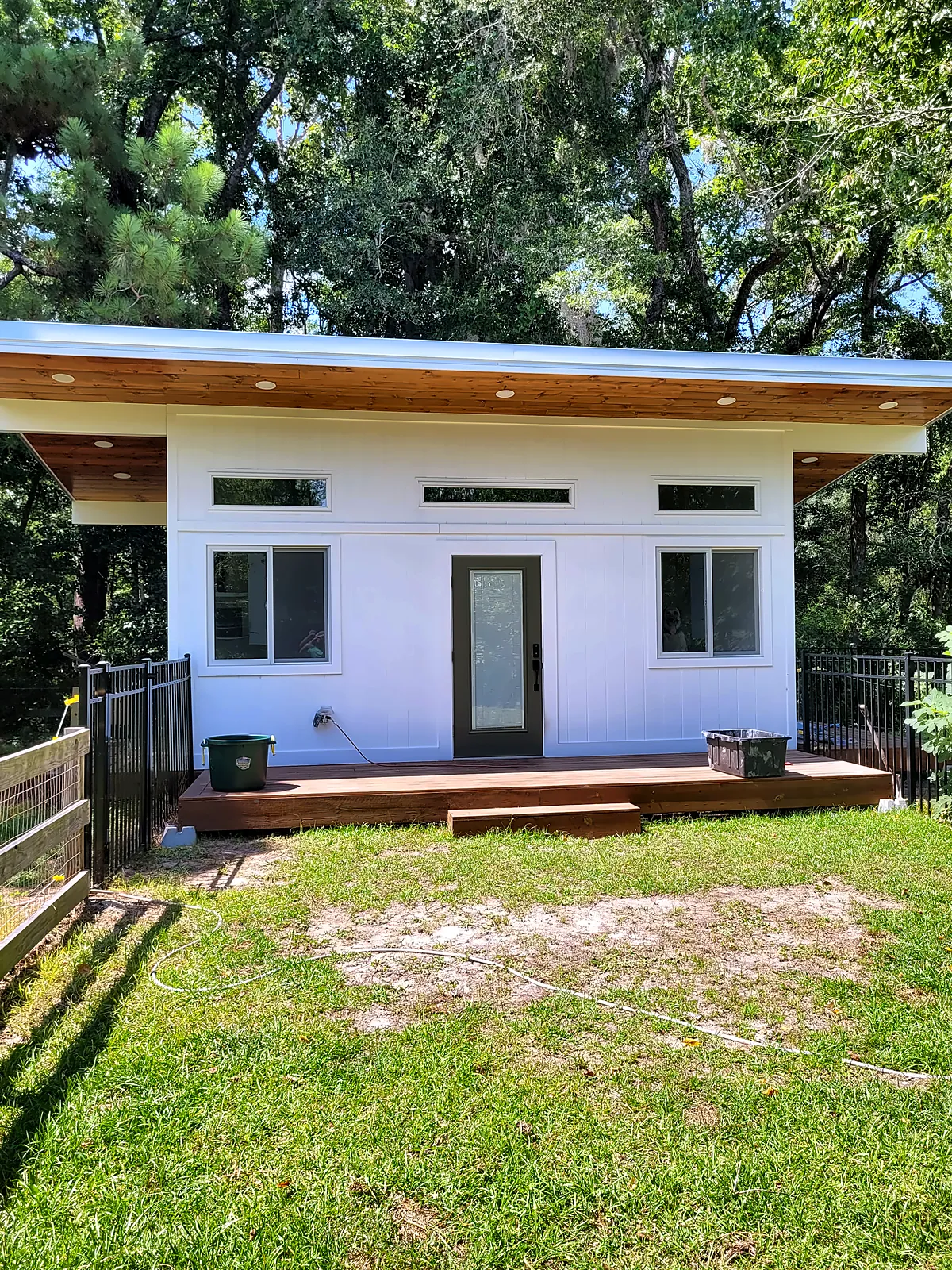 Backyard studio with deck and lawn