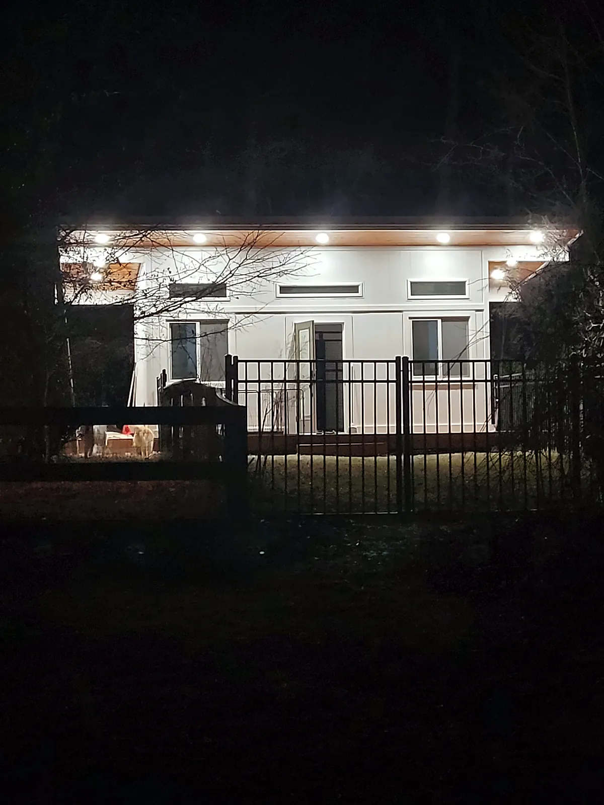 Backyard studio lit at night with soffit lighting