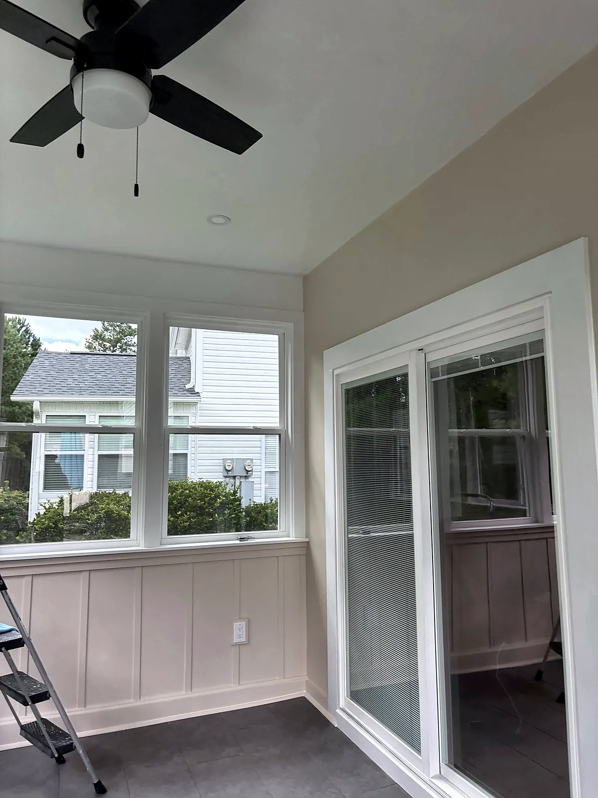 Sunroom interior with glass door and window walls