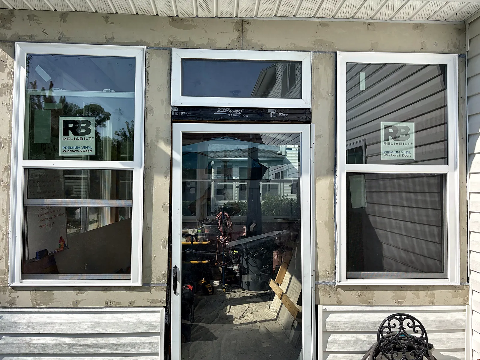 Sunroom exterior with new windows, transoms and door